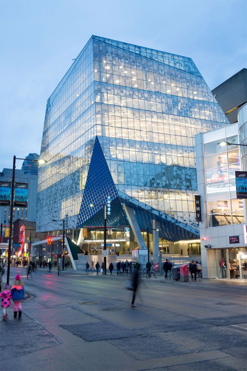 Centro estudantil da Universidade de Ryerson  Abrangendo 14.200 metros quadrados e subindo oito níveis, o centro estudantil Lernin Centre (SLC) fica localizado na cidade de Toronto, no Canadá e pertence ao campus urbano da Universidade Ryerson. O escritório Snøhetta, responsável pela obra, optou por uma fachada de vidro totalmente personalizada com a tecnologia de impressão digital em vidro. A estrutura de concreto é revestida com três mil painéis em vidro impresso digitalmente, o que minimiza o ganho de calor solar e resulta em condições de luz variáveis dentro do edifício. O padrão da fachada, consistindo de formas assimétricas, destina-se a enquadrar as vistas da cidade. O edifício também estabelece uma identidade para a universidade e a conecta melhor com a paisagem urbana.